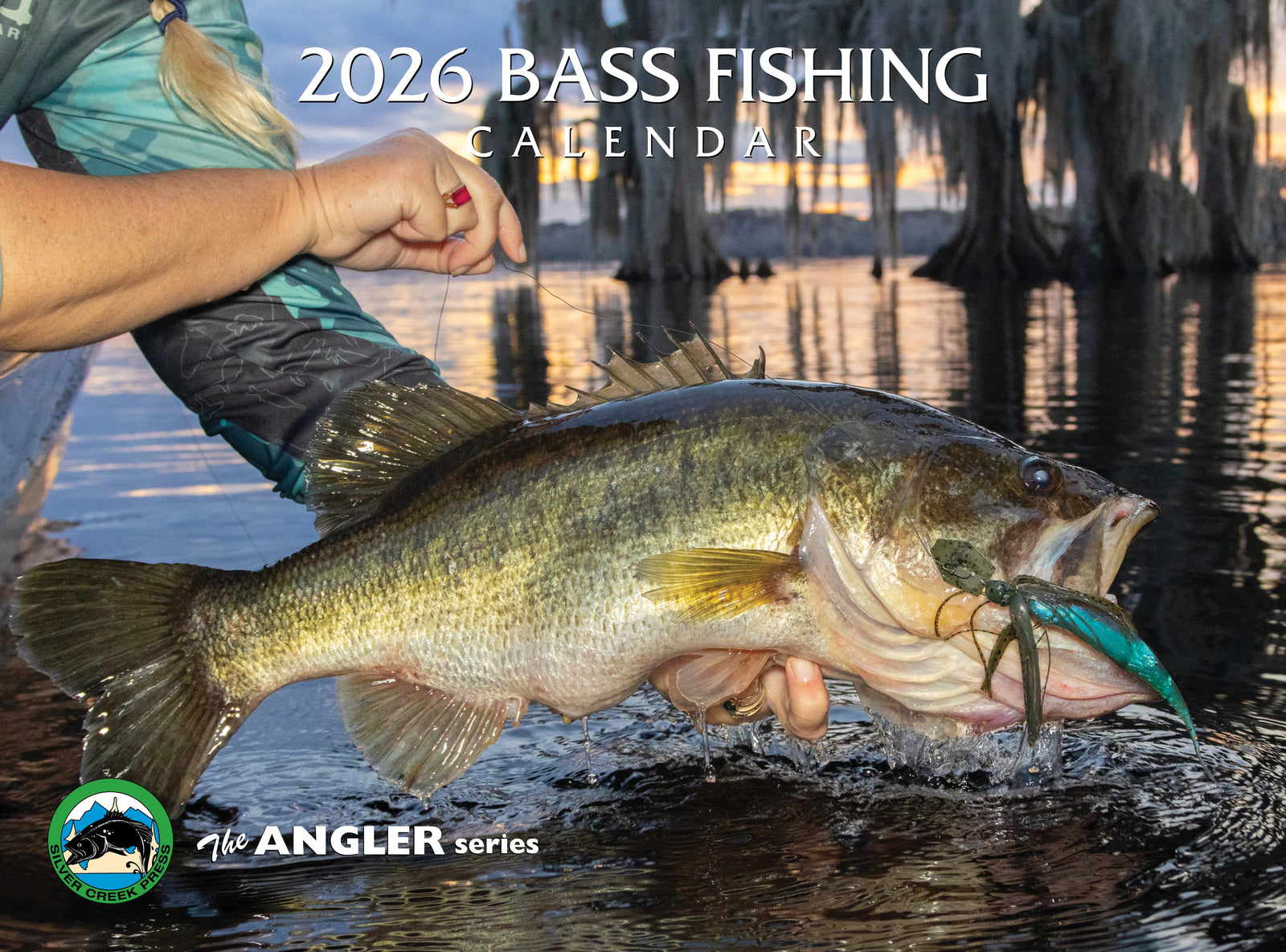 2026 Bass Fishing calendar featuring a person holding a large bass with a blurred lake background.