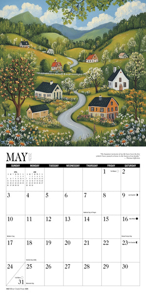 Calendar with a scenic illustration of a village landscape, featuring houses, trees, and a river. Open to the month of May.