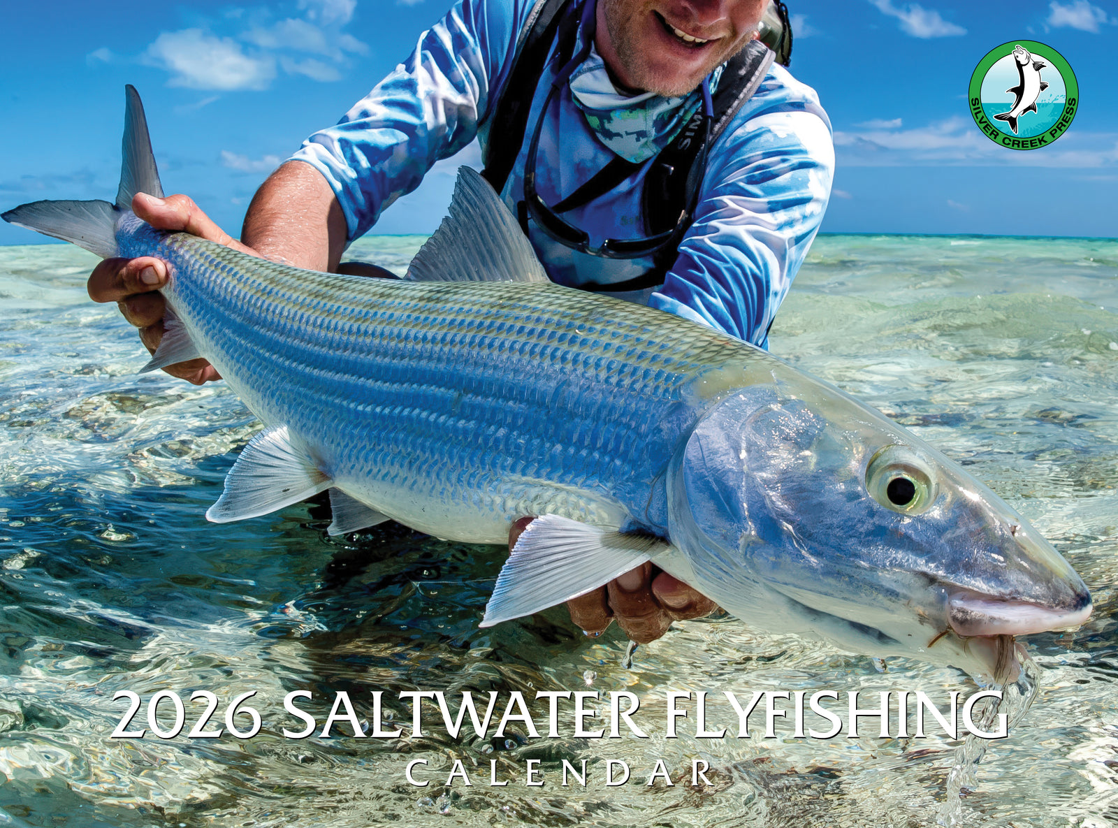 Person holding a large fish with '2026 Saltwater Flyfishing Calendar' text in the foreground.