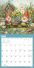 Calendar page for May with garden gnomes in a garden setting