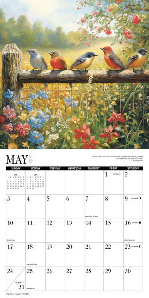 Calendar page for May with birds on a branch and flowers in the background